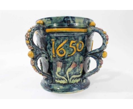 Castle Hedingham Edward Bingham blue glazed pottery four handled jug / loving cup with applied floral decoration and 1650, th