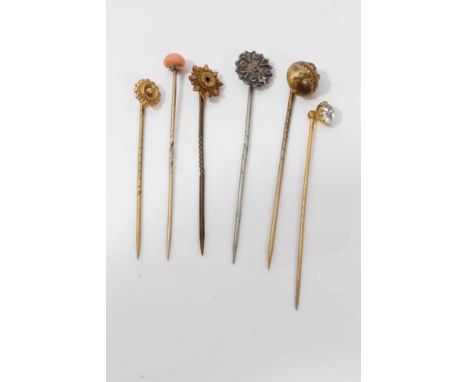 Six Victorian stick pins to include one silver, two gold, Naval pin, antique coral and a synthetic white stone