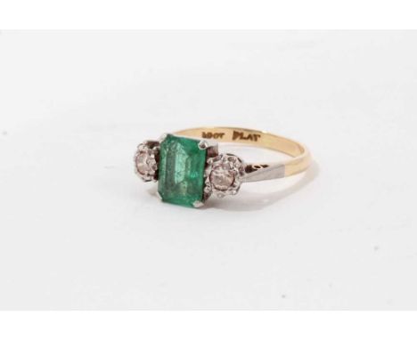 18ct gold emerald and diamond ring with a rectangular step cut emerald flanked by two old cut diamonds , in platinum setting 