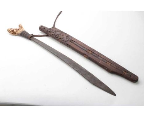 Borneo Dayak Head hunters sword with carved bone hilt with rope bound grip, in carved wood scabbard