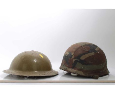 Second World War British Army helmet, in sand coloured camouflage finish, with naming under brim, together with an American h