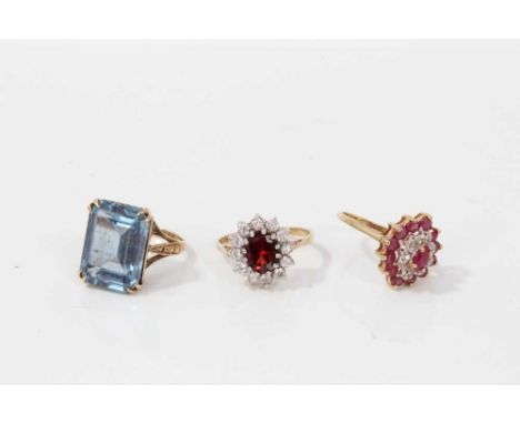 Three 9ct gold gem set rings to include ruby and diamond cluster, size M, garnet and synthetic white stone cluster, size N an