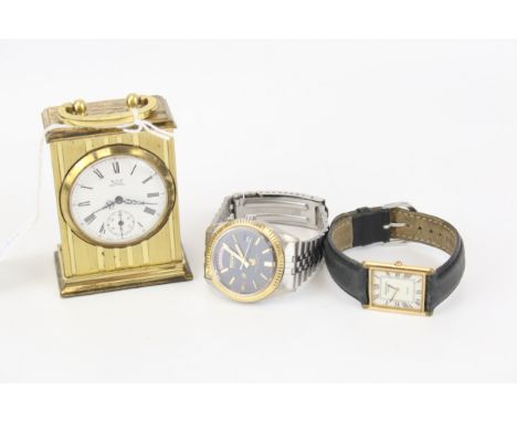 Two watches and a small carriage clock. Consisting of a gents Ricoh 2003 stainless steel bracelet, day/date aperature; a Raym