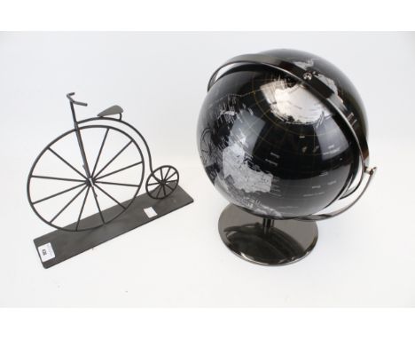 A vintage globe and a metal model of a penny farthing. The largest measuring approximately 31cm high