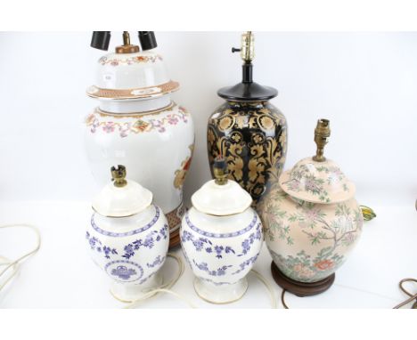 Five contemporary oriental lamp bases. Including a pair with blue and white details, H30cm, a ceramic example glazed in black