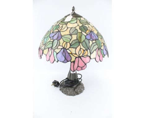 A Tiffany style table lamp. With leaded effect shade and cast metal base, H50cm