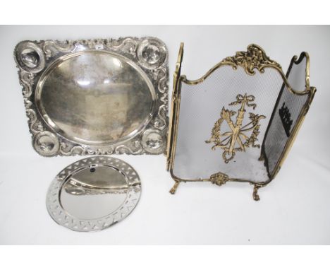 An Alessi tray, another example, and a fireguard. The pierced metal Alessi tray marked INOX 18/10, diameter 49cm, the second 