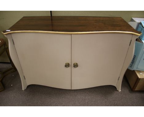 A contemporary serpentine commode style two door sideboard cabinet. With dark stained wood top, guilt edge and brass handles,