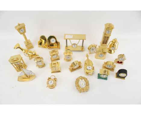 A collection of 22 brass cased miniature novelty clocks/timepieces. Including a ship's wheel, a street lamp, a golf bag and a