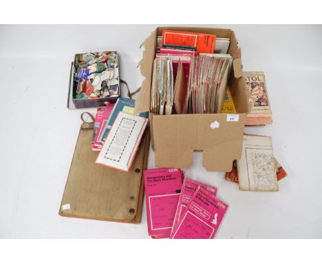 A collection of Ordnance Survey maps and a box of labels. Featuring multiple locations within the UK and a canvas map carrier