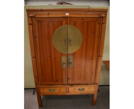 A Chinese 'marriage cabinet'. Two door cupboard with internal set of two drawers, with two drawers below and raised on square