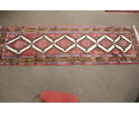 A kilim style wool runner carpet. 280cm x 82cm