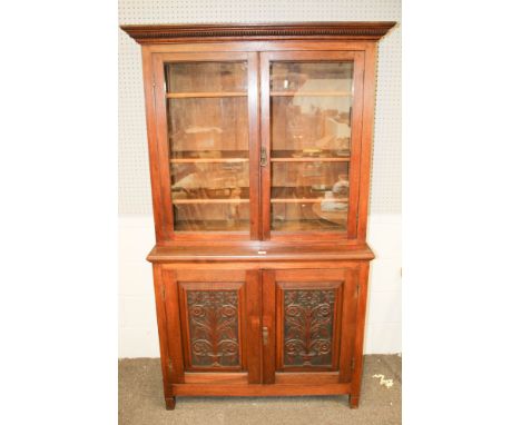 A Victorian or later glazed top dresser. The two door top with three adjustable bookshelves on a two cupboard door base (with