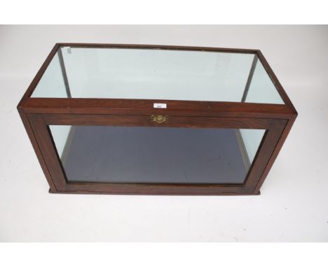 A Victorian mahogany glazed display cabinet. The hinged door opening via a latch, H46cm x W90.5cm x D46cm