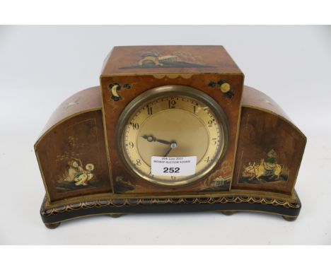 A 20th century chinoiserie style mantel clock. Walnut veneer, gilt and lacquer decoration, gilt metal dial with Arabic numera