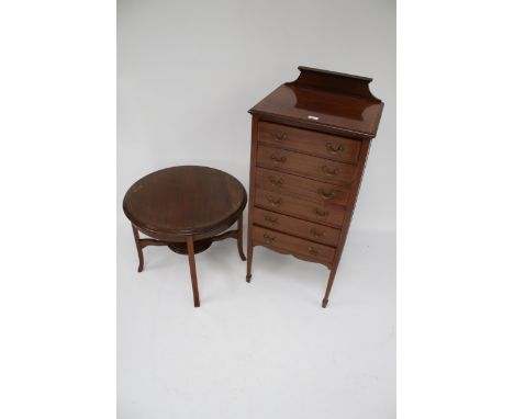 A music cabinet and a circular table. Consisting of an Edwardian style multi-drawer music cabinet, on tapering square support