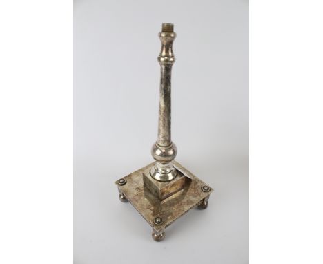 A silver plated lamp base. Of architectural form, tapering column on a square plinth with ball feet, H27.5cm