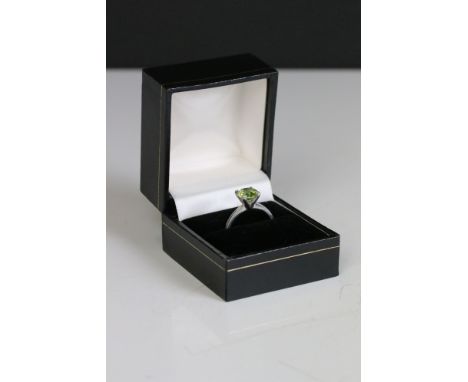 A 925 sterling silver ring set with green centre stone. 