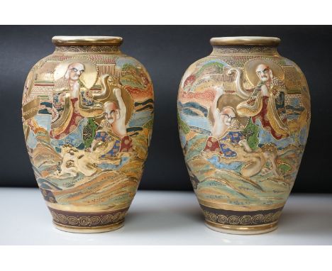 Pair of 20th Century Japanese Satsuma vases of ovoid form, with relief moulded seated figures and beaded enamel decoration, 2