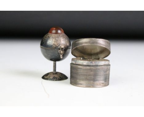 Two vintage white metal pill boxes, one set with amber coloured cabochon. 