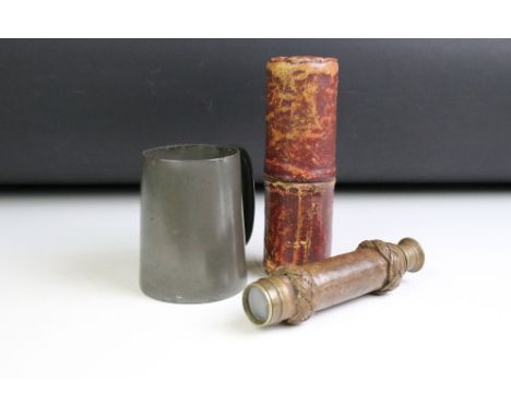 An antique pewter tankard with glass bottom together with a vintage pocket telescope with leather braided cover. 