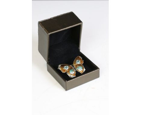 A silver and enamel butterfly brooch. 