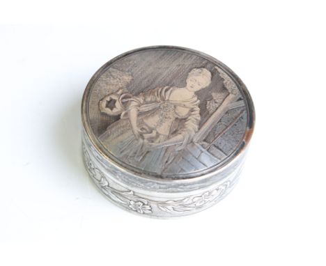 A vintage white metal powder jar with figural decoration to the lid and foliate decoration to the surround. 