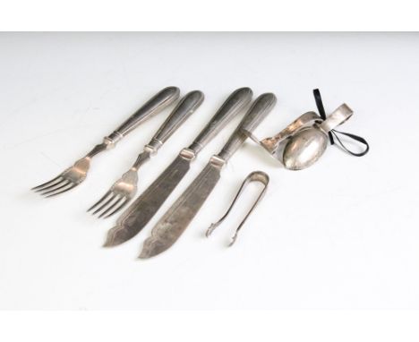 A hallmarked sterling silver christening set together with silver sugar tongs and silver plated cutlery. 