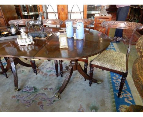 A reproduction mahogany dining table with rectangular top, on turned legs and a set of six Regency mahogany framed dining cha