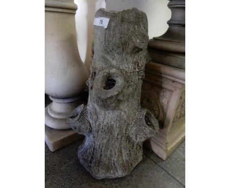 A concrete trunk form planter and a brown painted rustic planter