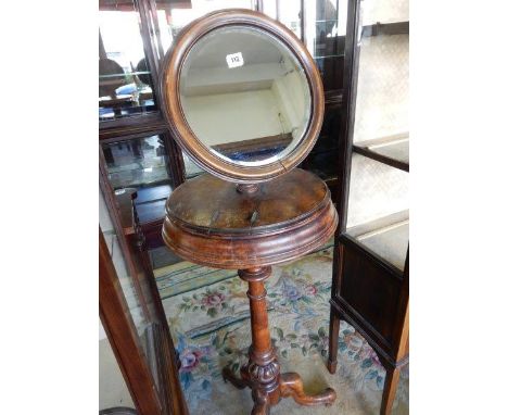 A Victorian mahogany shaving stand with circular mirror, on turned column and three carved downswept legs