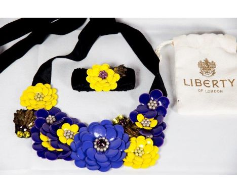 A Liberty black velvet belt decorated to the front in yellow and purple enamel with flowers, sequin and paste set leaves and 