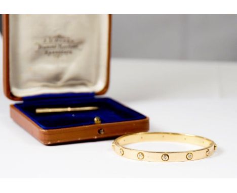 A Cartier 18ct. gold love bangle, the top set five diamonds - 6 1/4cm. dia. complete with original screwdriver