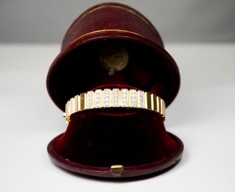 A heavy 18kt. gold hinged bangle of sectional form, the top set twenty eight diamonds - 5 1/2cm dia.
