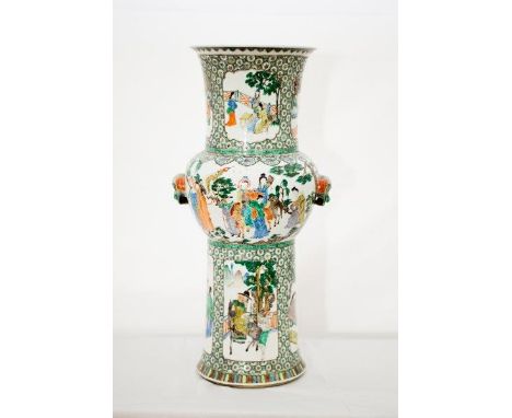 A Chinese vase decorated in famille verte enamel colours with figures in garden scenes within panels - 22 1/4in. high