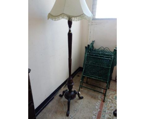 A mahogany standard lamp with carved and fluted column, on tripod base with hairy paw feet