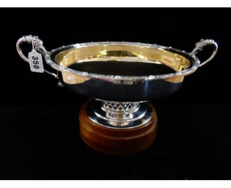 A silver double handled pedestal bowl with Celtic style band of decoration, two sea horse style handles, gilt washed interior
