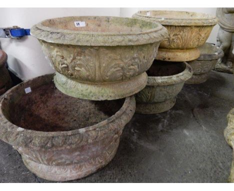 Five matching concrete garden pots with raised decoration of leaves