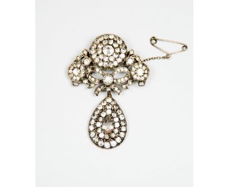 A silver and paste set pendant brooch of flower head and ribbon tie design