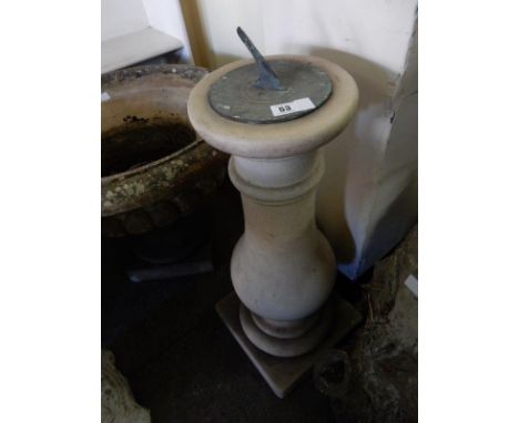 A sundial on a stone baluster form column and circular base