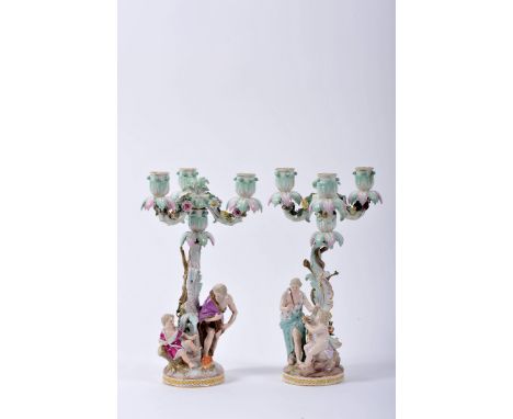 A pair of three-light candelabra, possibly Meissen porcelain, sculpted structures en relief "Figures and children by the tree