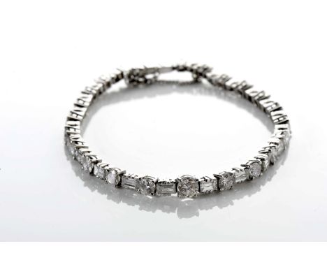 A bracelet, 500/1000 platinum, set with 23 baguette cut diamonds weighing approximately 4.60 ct. and 23 brilliant cut ones wi