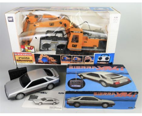 A New Bright 1:20 scale remote control CAT Power Excavator, boxed, and an Asahi Ford remote control Sierra XR4i car, 31cm lon