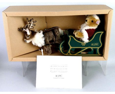 A Steiff limited edition Father Christmas bear, on wooden sleigh with reindeer, No.632/2500 with certificate, 35cm long in or