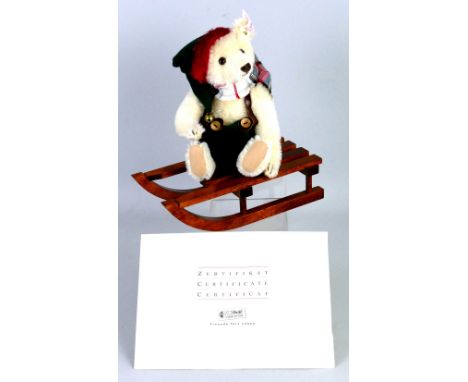 A Steiff limited edition bear, on wooden sledge, No.877/4000 with certificate 21cm high in original box