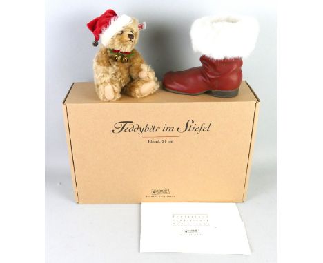 A Steiff limited edition Christmas teddy bear and boot, No.519/4000 with certificate, 21cm high in original box with outer pa