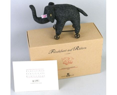 A Steiff limited edition elephant on wheels, No.606 with certificate, 12cm high in original box