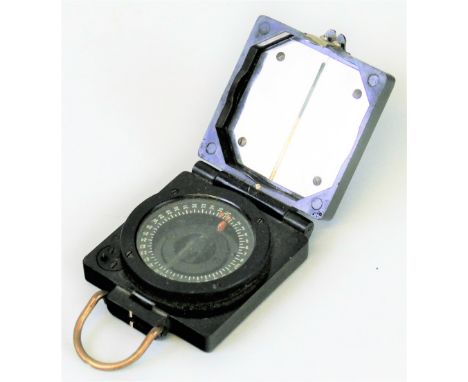 A WWII T.G. Co. Ltd magnetic marching compass, in square bakelite case inscribed with broad arrow and B130060, 6cm square