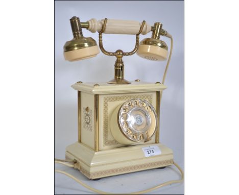 A retro / vintage rotary dial  cradle telephone having a modern telephone connection H30cm