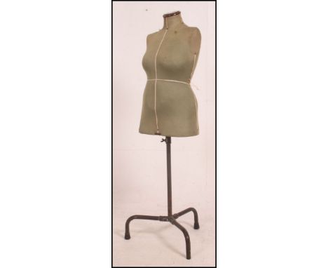 A 1950's Singer tailor's dress makers dummy standing on an adjustable tubular metal stand on tripod feet. 139cm high x 48cm w